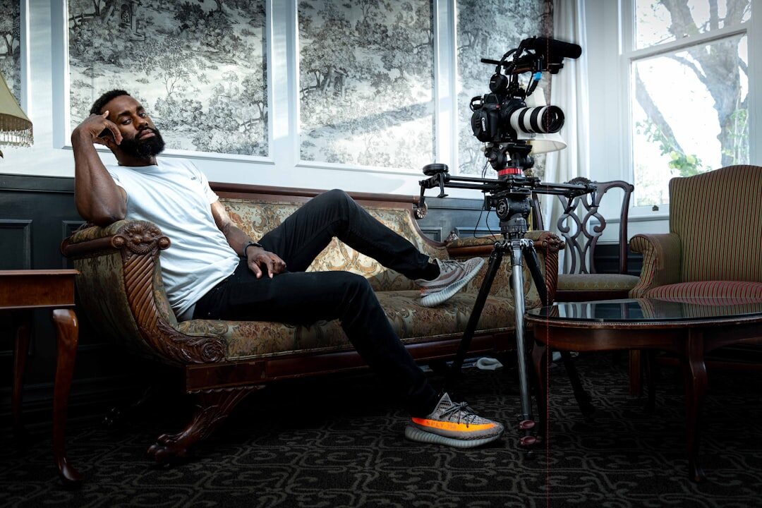 A relaxed and confident professional sitting naturally in front of a camera during an interview